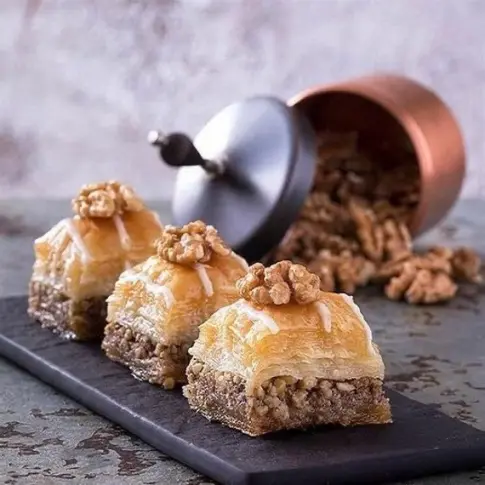 Walnut baklava pieces topped with whole walnuts